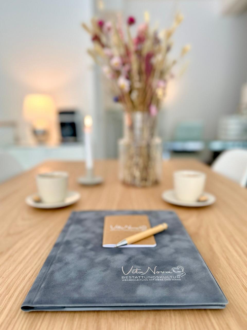 VitaNova Besprechungstisch mit Mappe und Kaffeetassen